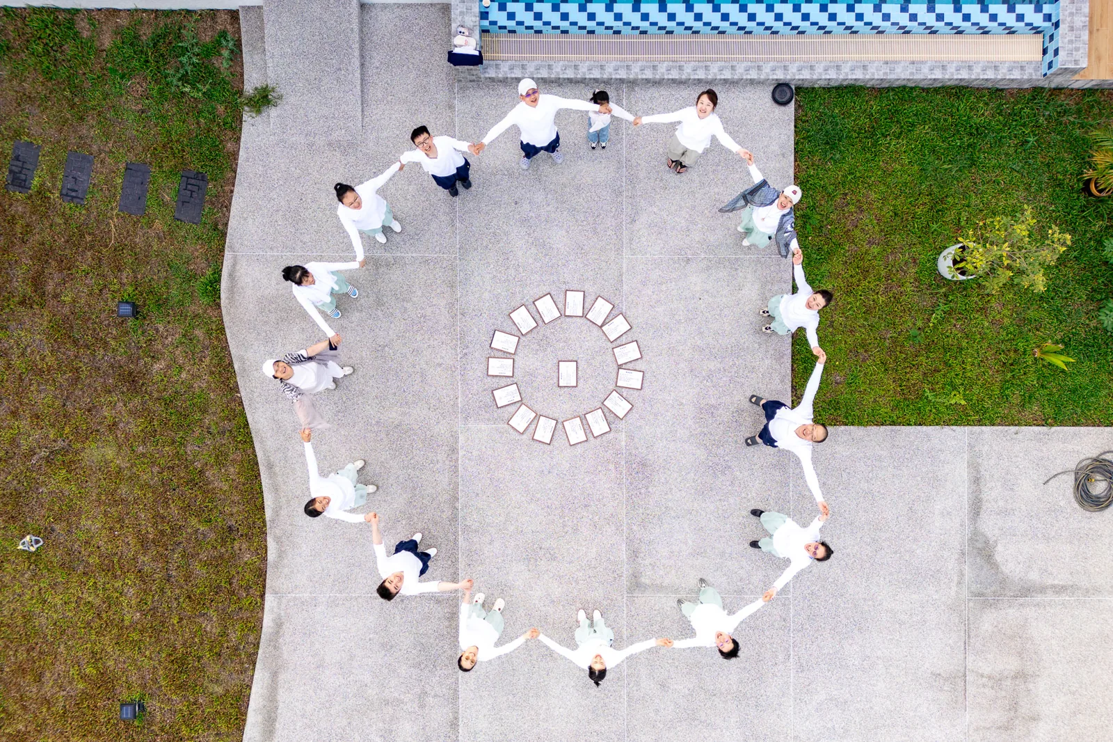 People holding hands in a circle outdoors