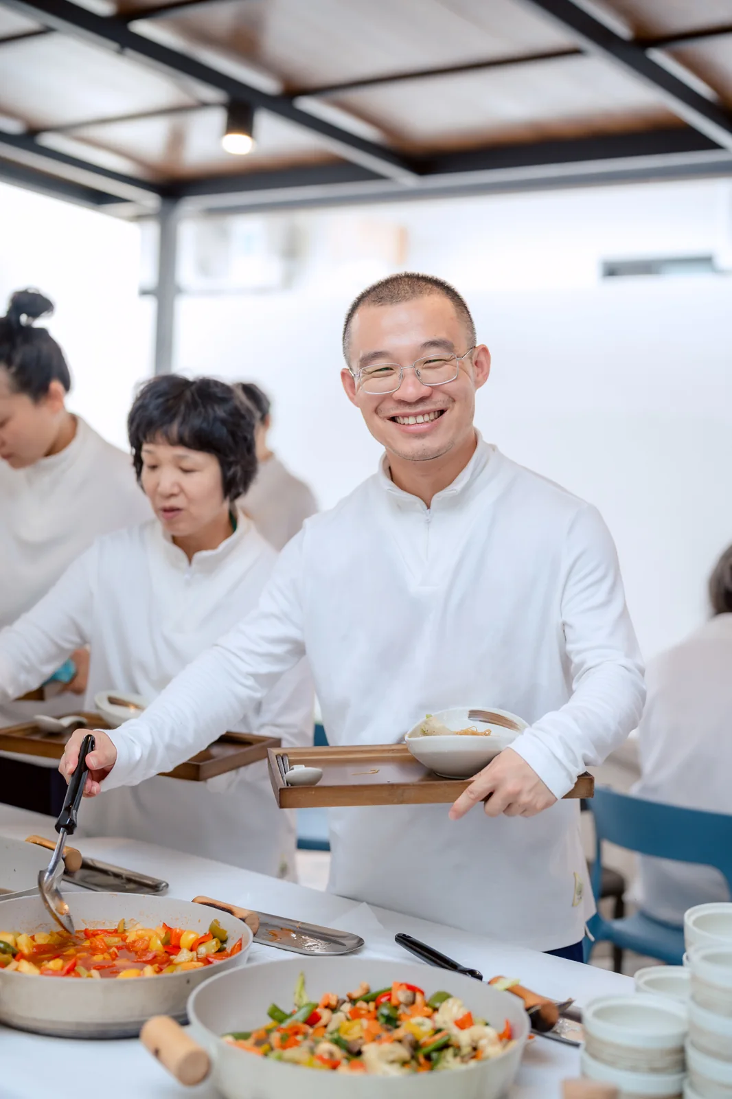 A participant smiling while collecting food