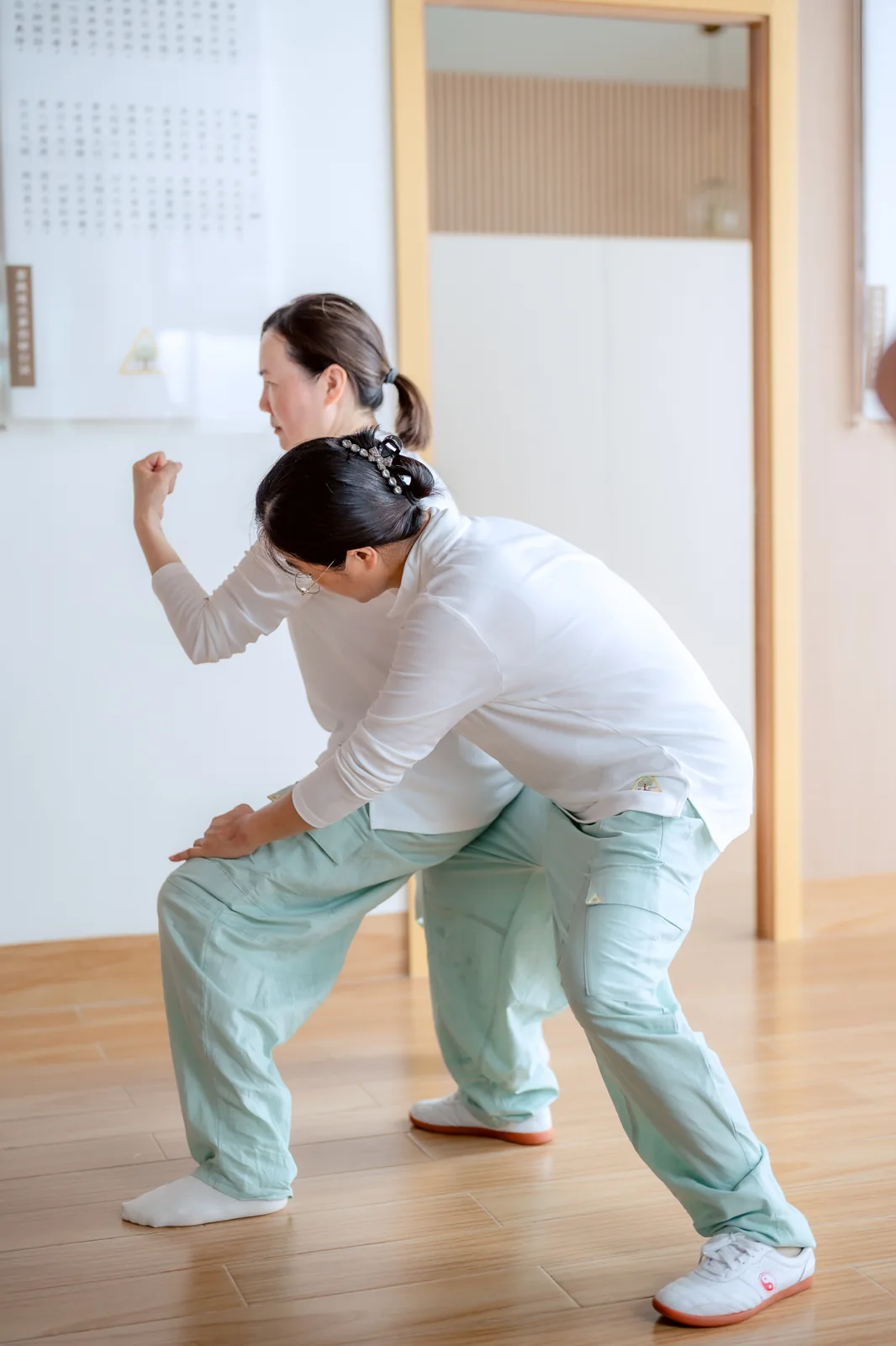 Two people practising a movement together